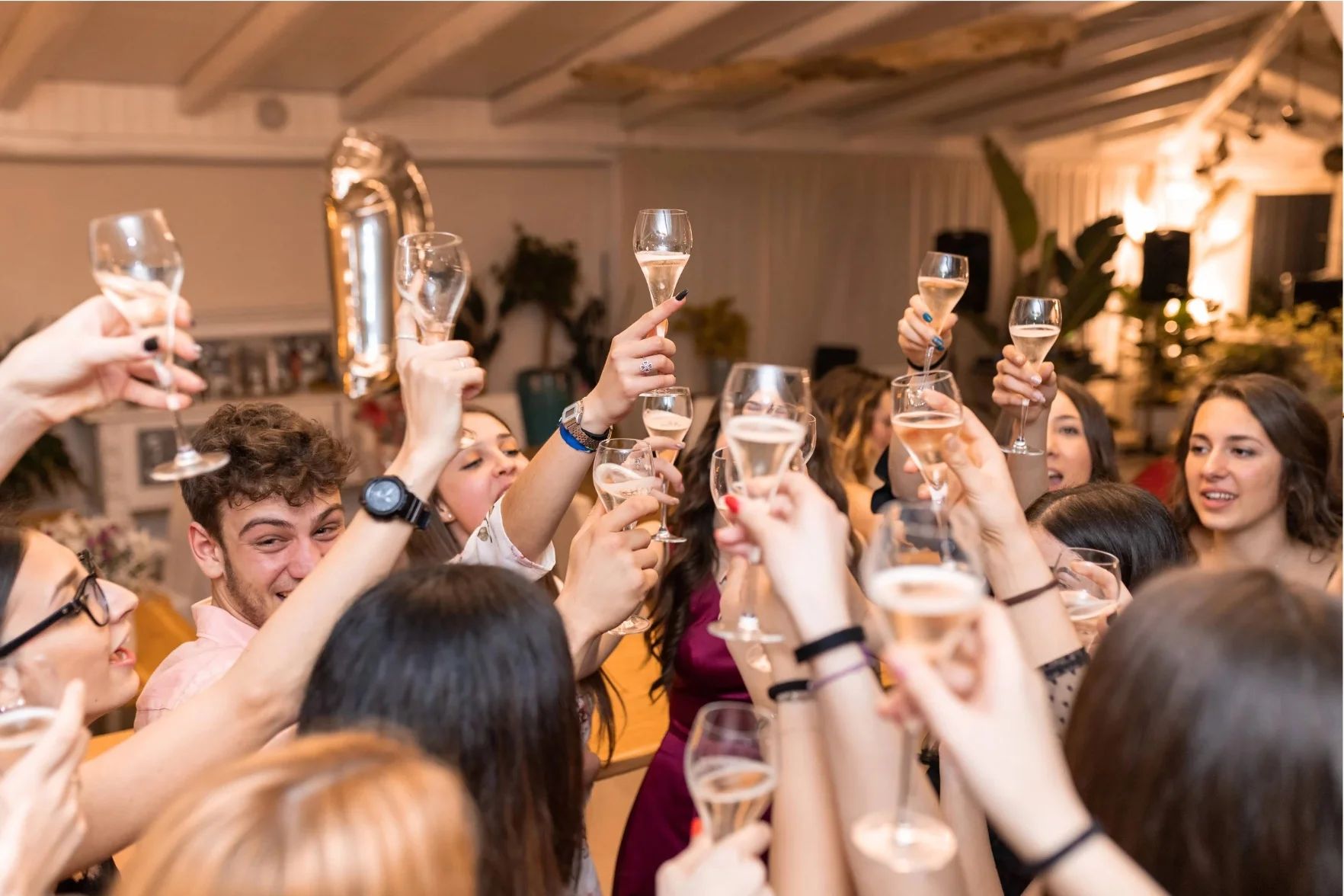 Guests raising champagne glasses together at a celebration