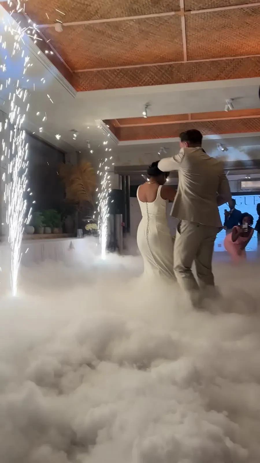 Cold sparks either side of a couple dancing on low fog